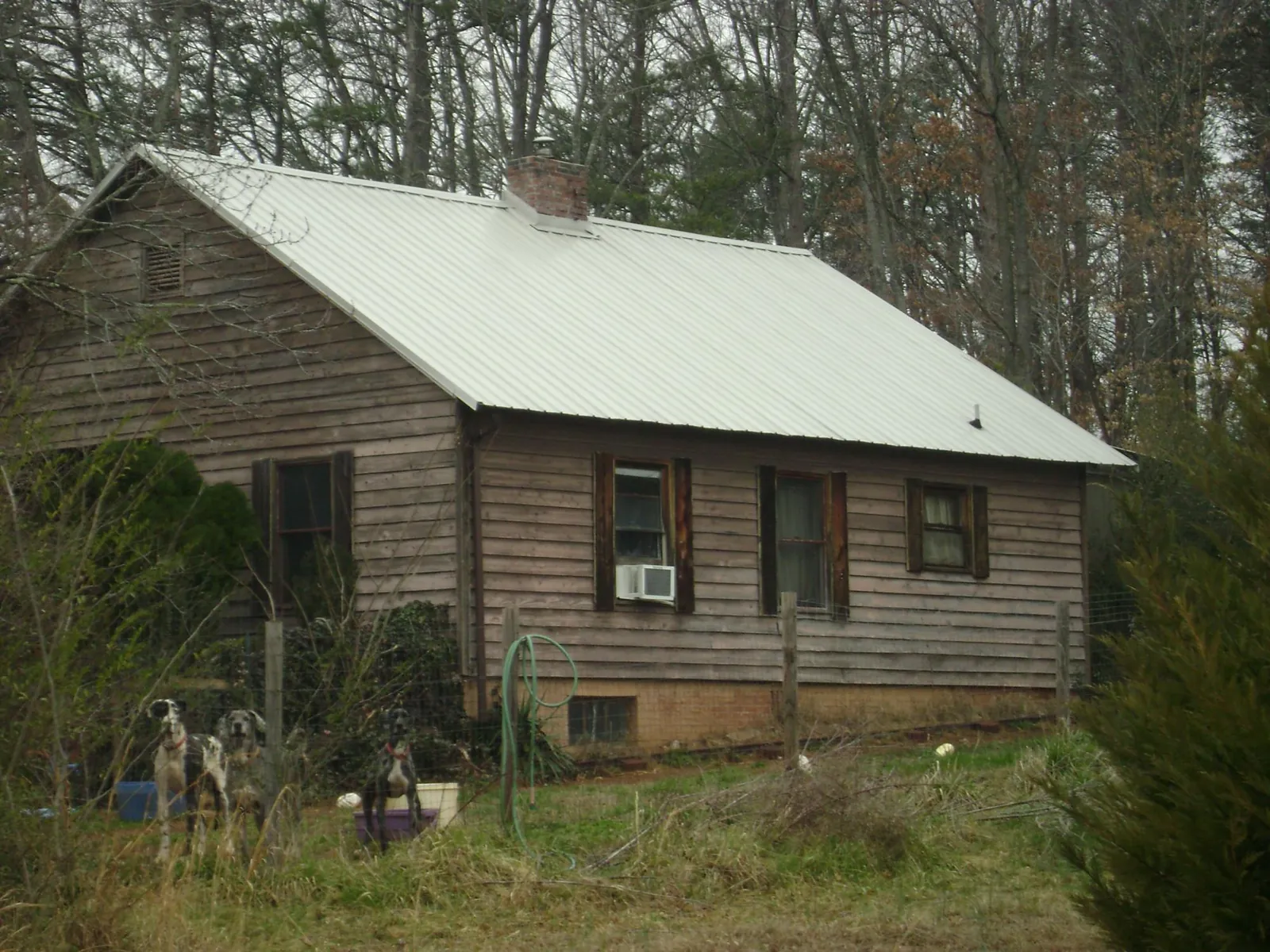 White metal roof on an old wood sided farmhouse, from a Metal Roof Installation job in Stanhope